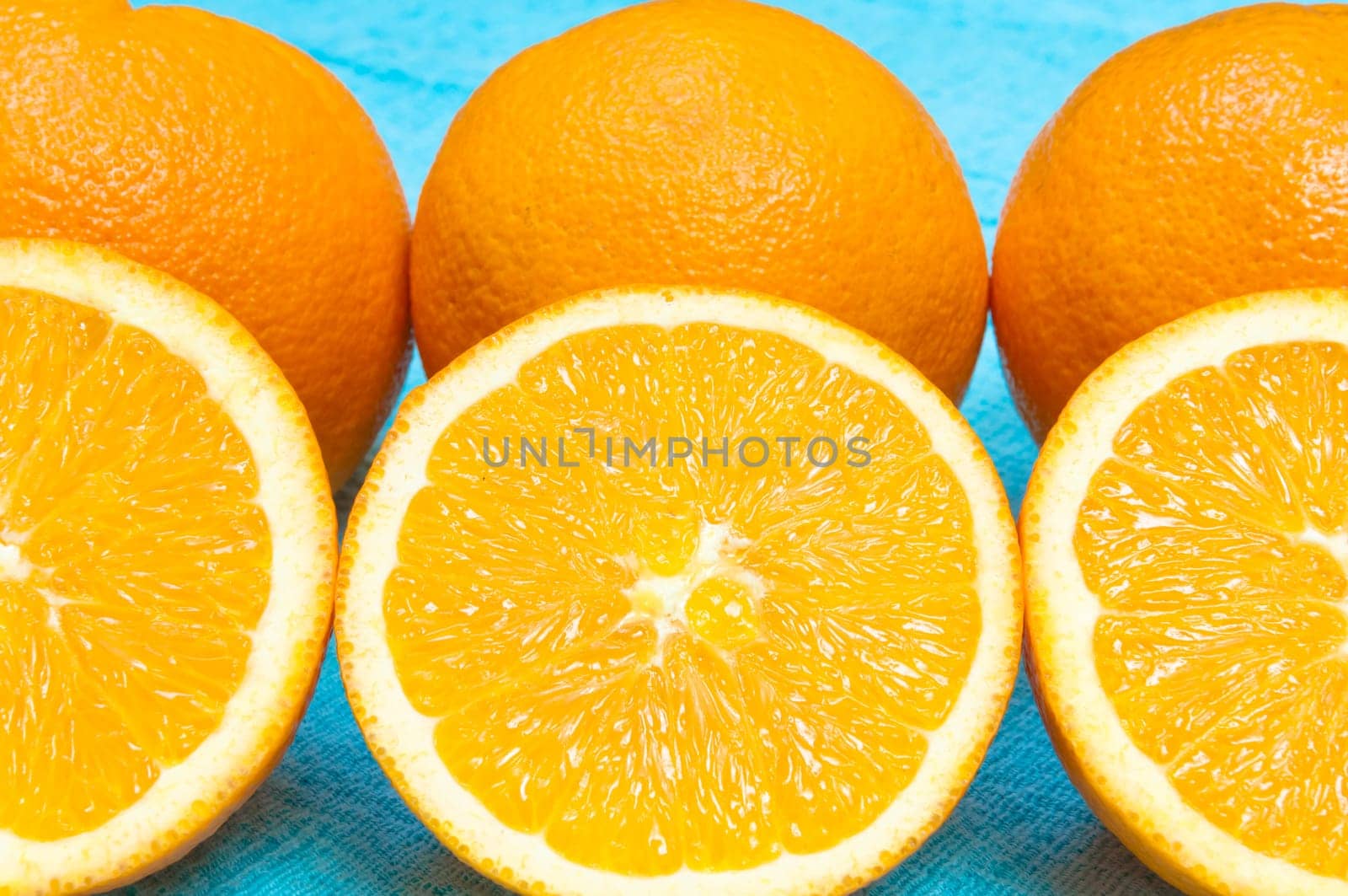Orange and lemon citrus fruit pattern on light blue background