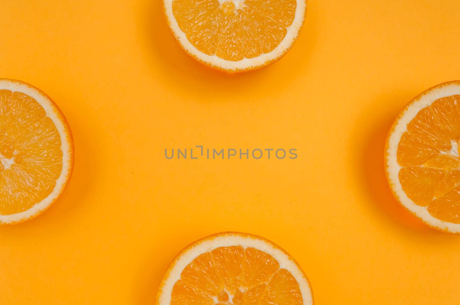 Orange pattern on orange colored background citrus arrangement