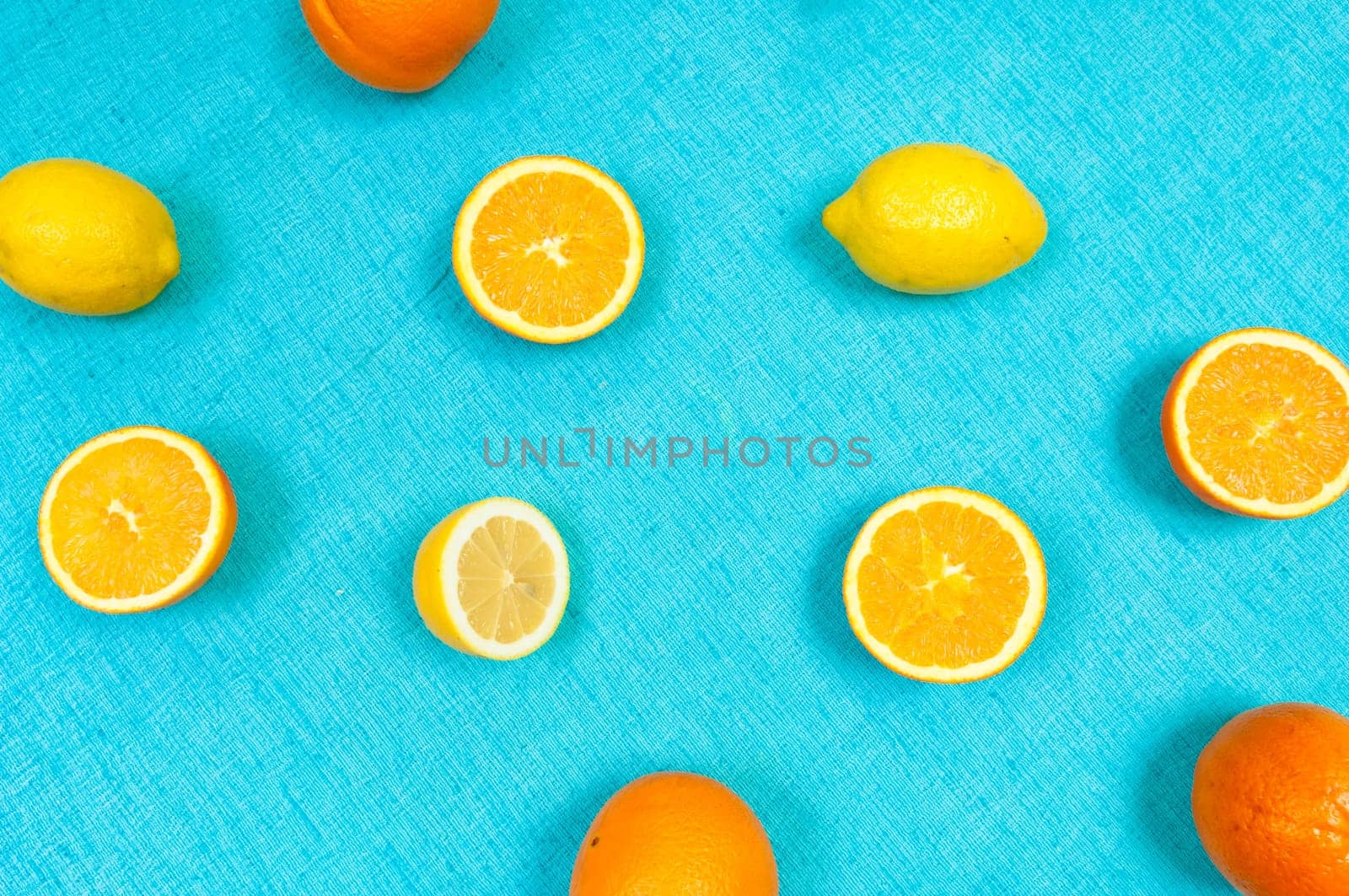 Orange and lemon citrus fruit pattern on light blue background