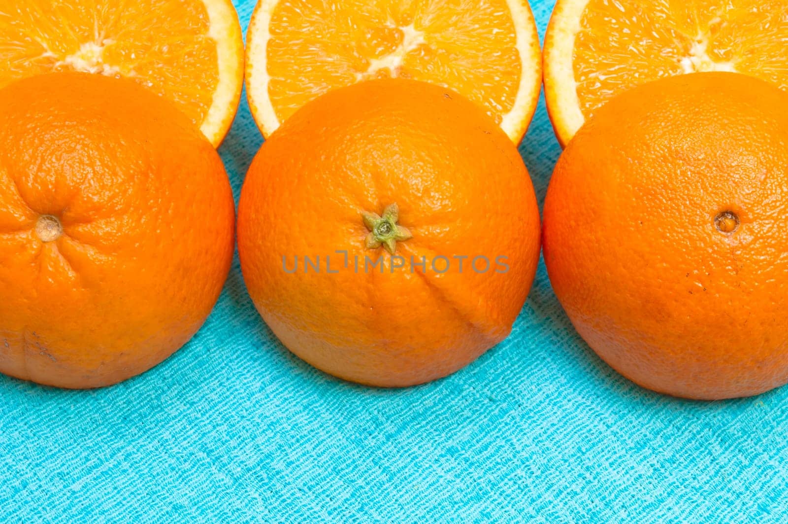 Orange and lemon citrus fruit pattern on light blue background
