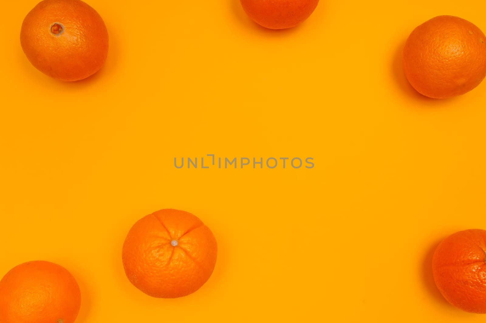 Orange pattern on orange colored background citrus arrangement