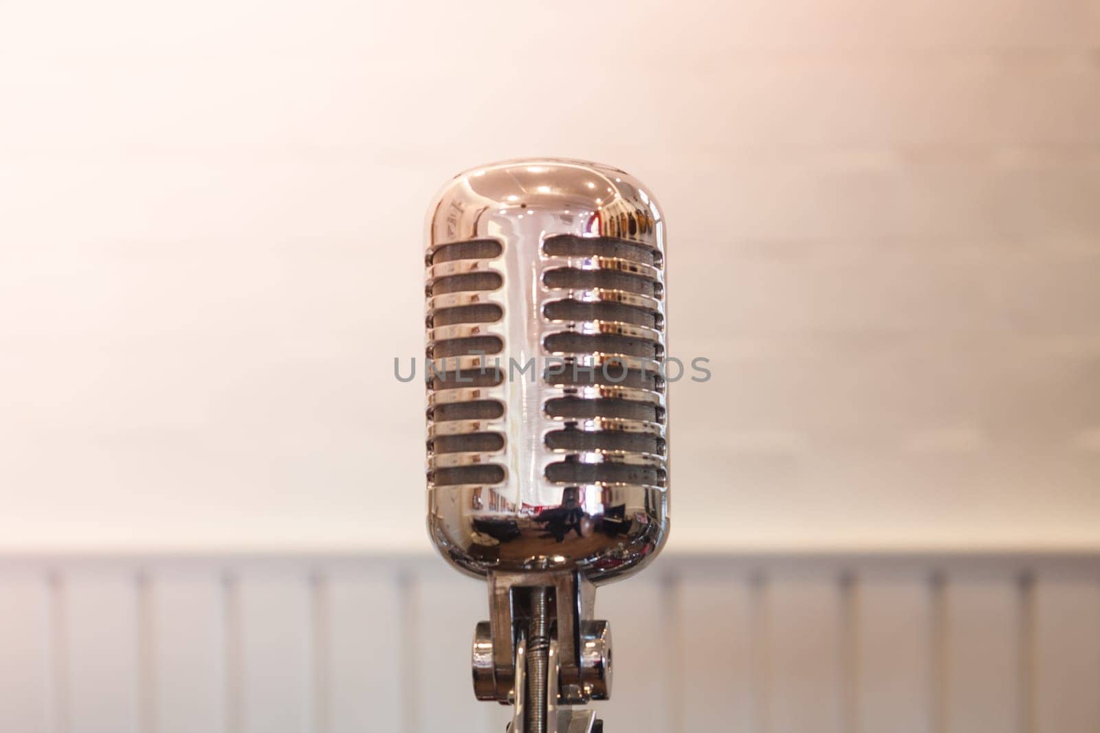 Vintage silver microphone with blurred background, stock photo