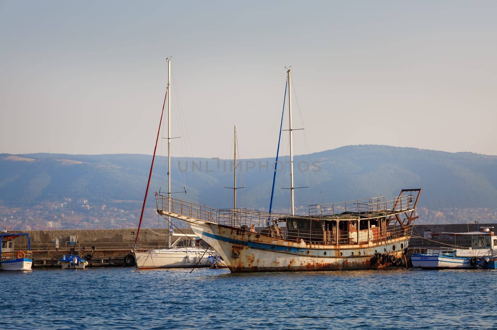 Nesebar, Bulgaria - September 10, 2014: Old rusty ship at the dock in the port of the old town of Nessebar, on the Black Sea coast.