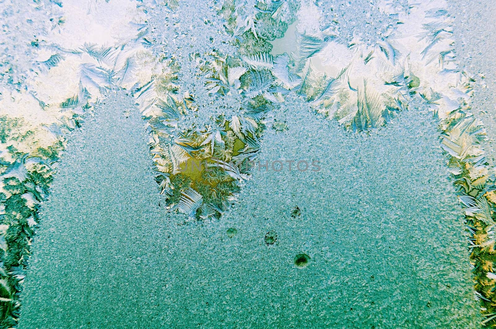 Beautiful frosty glass frostwork and ice flowers on window glass