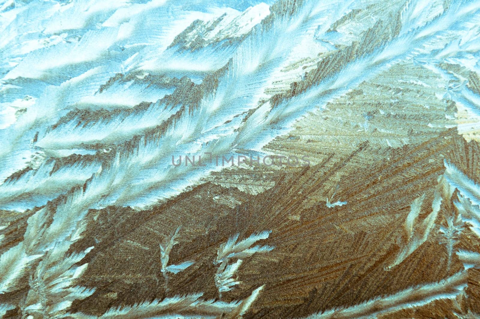 Beautiful frosty glass frostwork and ice flowers on window glass