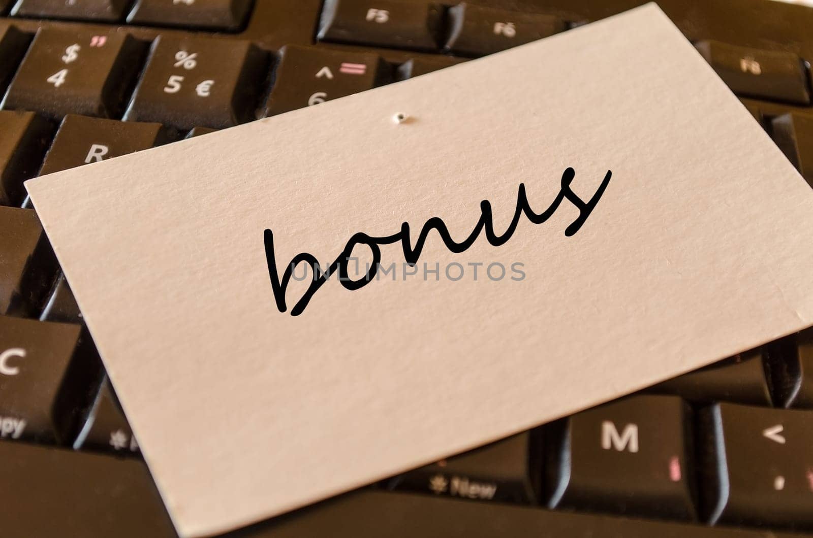 Bonus text concept over keyboard background