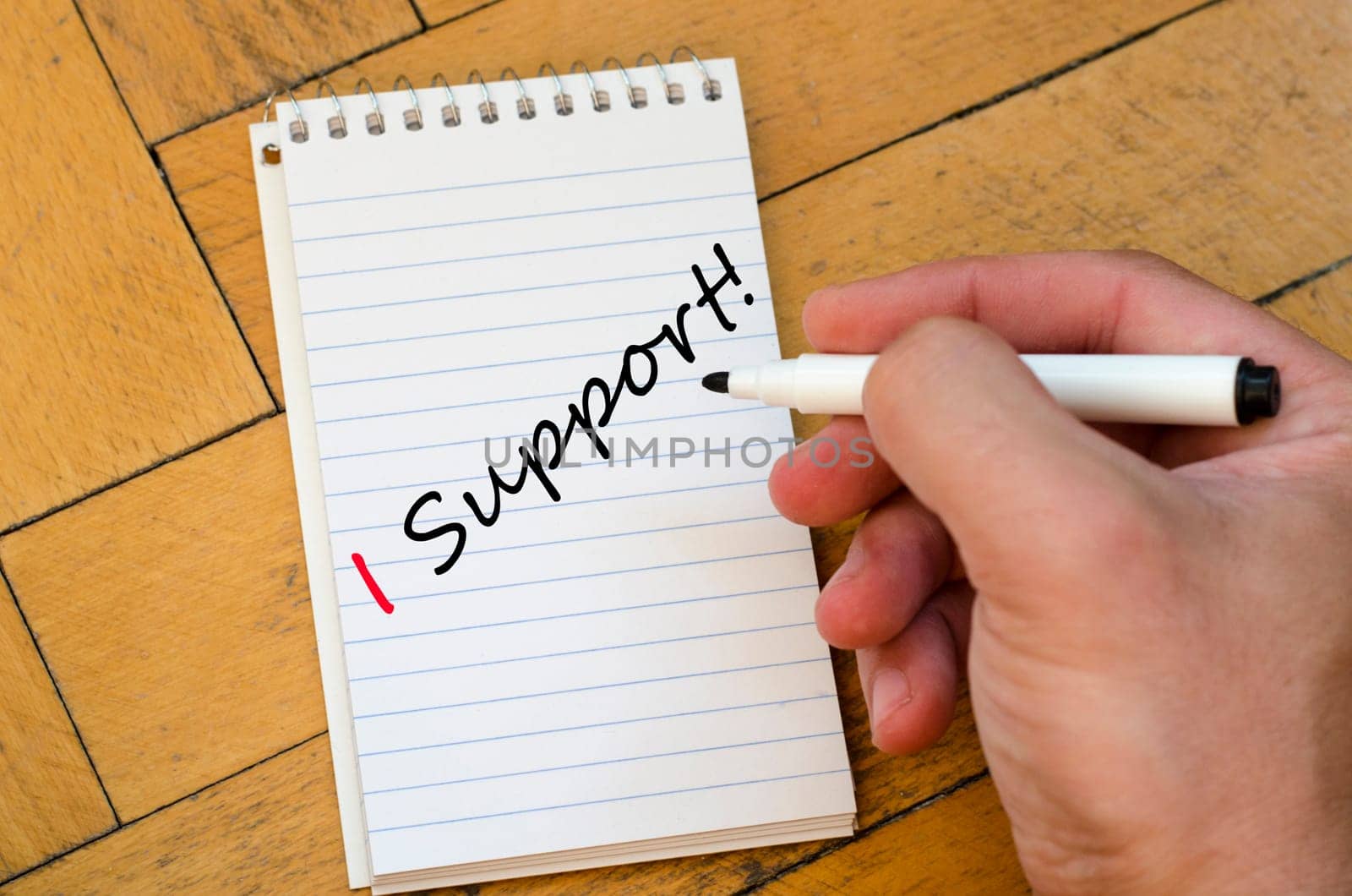 Human hand over wooden background and i support text concept