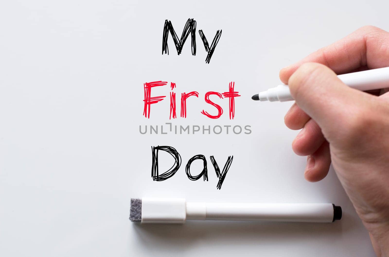 Human hand writing my first day on whiteboard