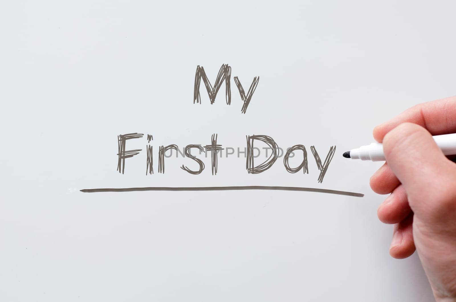 Human hand writing my first day on whiteboard