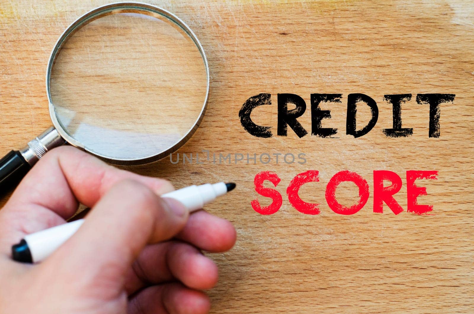 Human hand over wooden background and credit score text concept