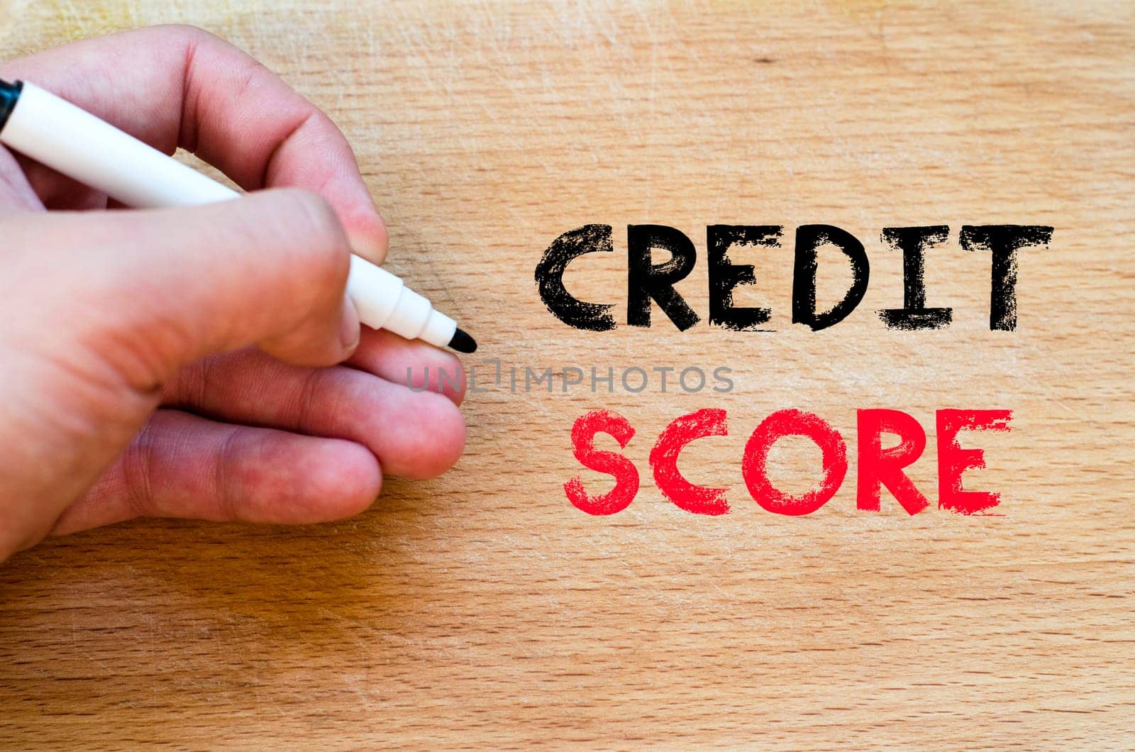 Human hand over wooden background and credit score text concept