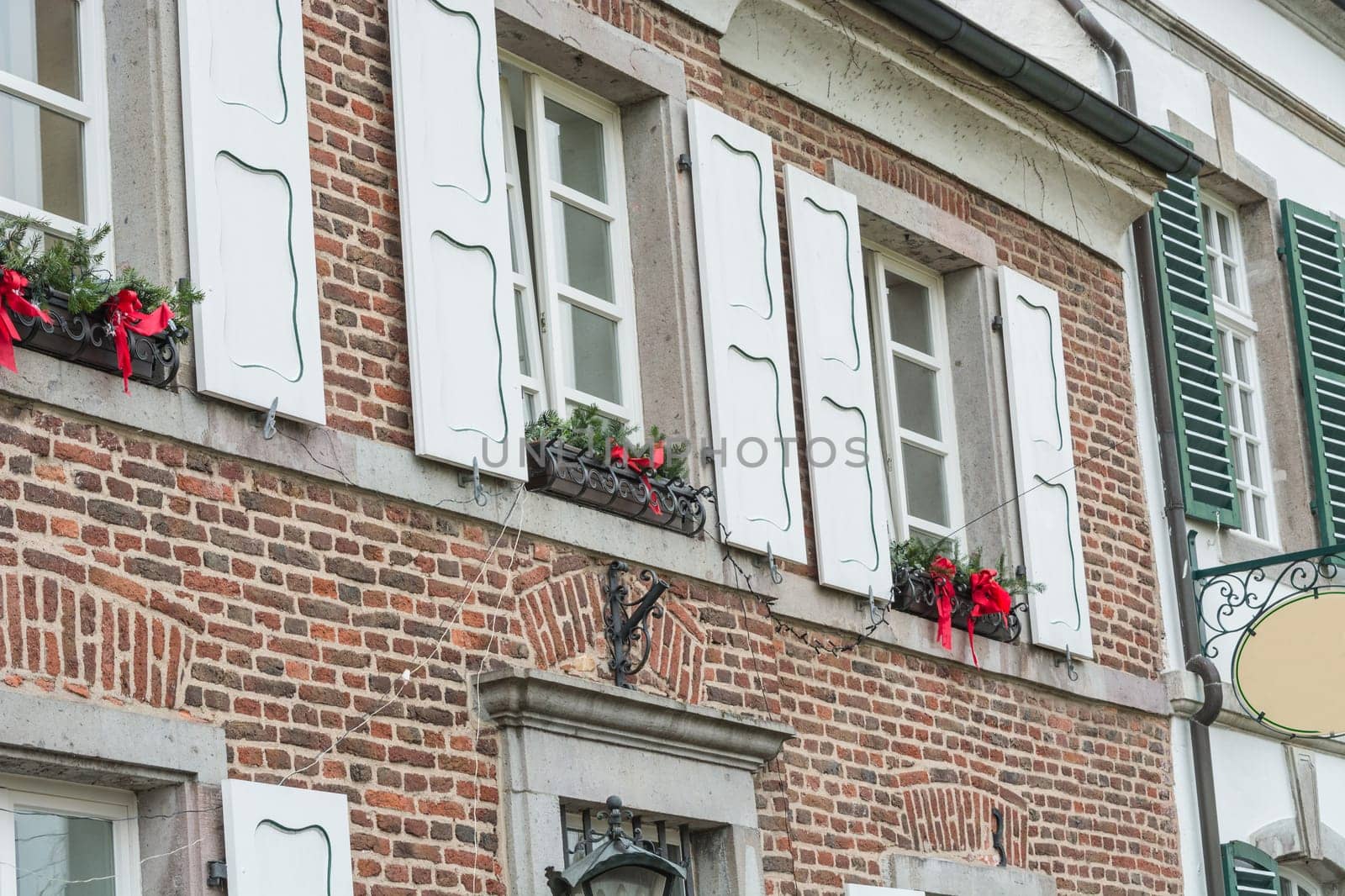Christmas decoration of an exterior wall of a house with brickwork. .