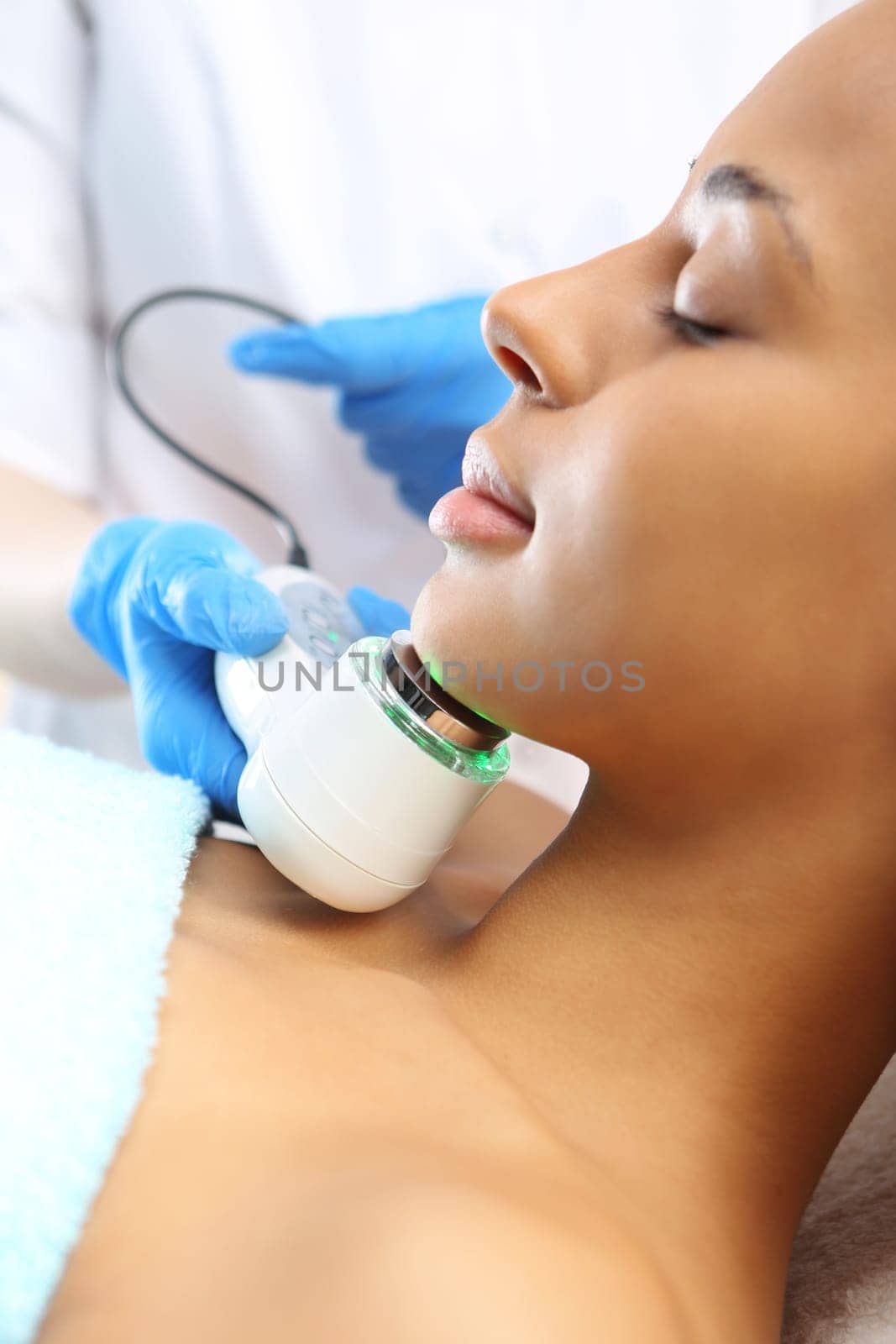 a woman's face during a treatment at a beauty salon\nultrasound infrared light,facial treatment\nultrasounds,a woman in a beauty salon\nlight therapy,a woman in a beauty salon\nacne treatment with light,a woman in a beauty salon