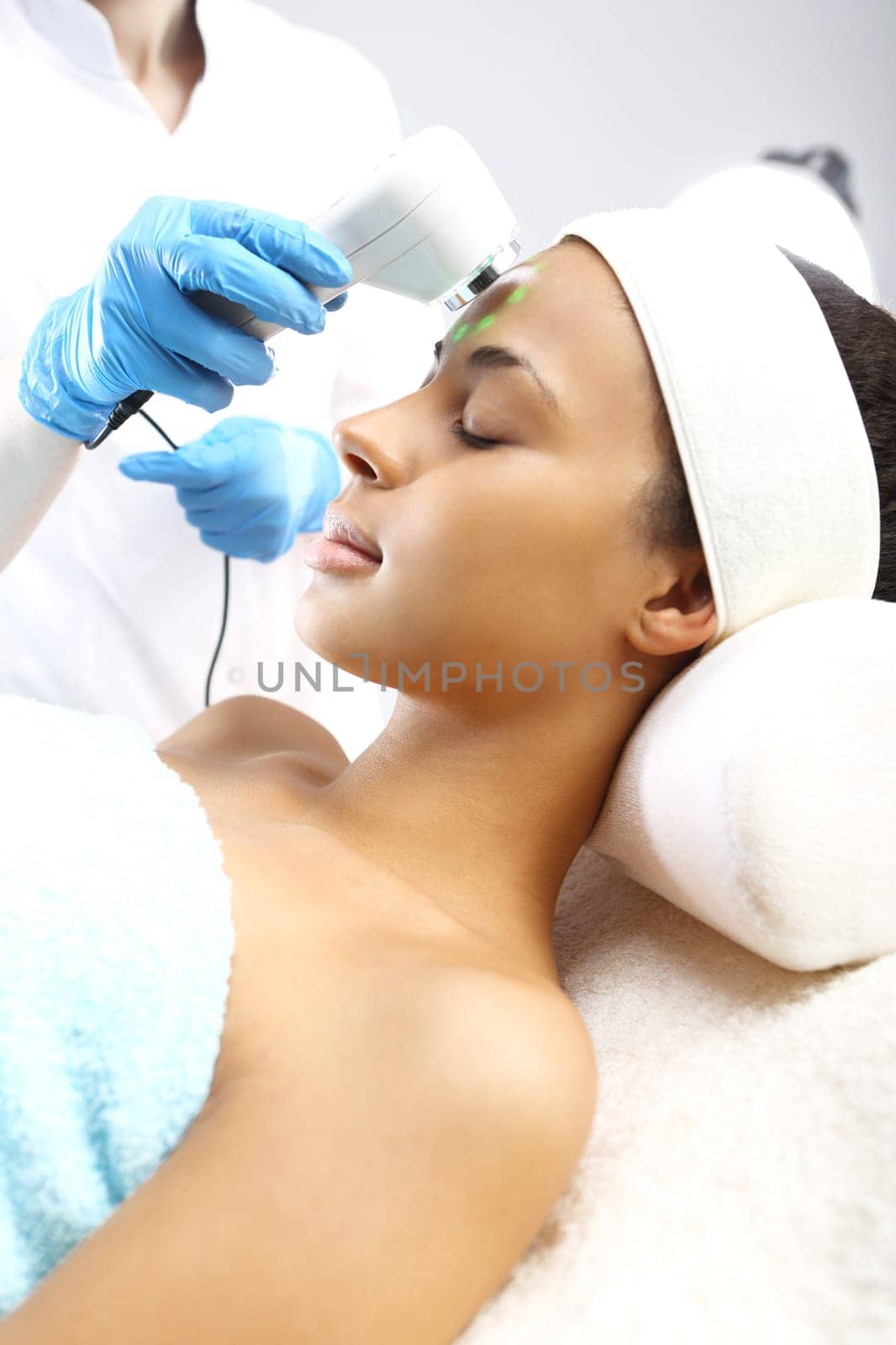 face of a woman during surgery in a beauty salon\nultrasounds of infrared light,cosmetic surgery on the face\nultrasounds,woman in the beauty salon\nlight therapy,woman in the beauty salon\nacne treatment light,woman in the beauty salon