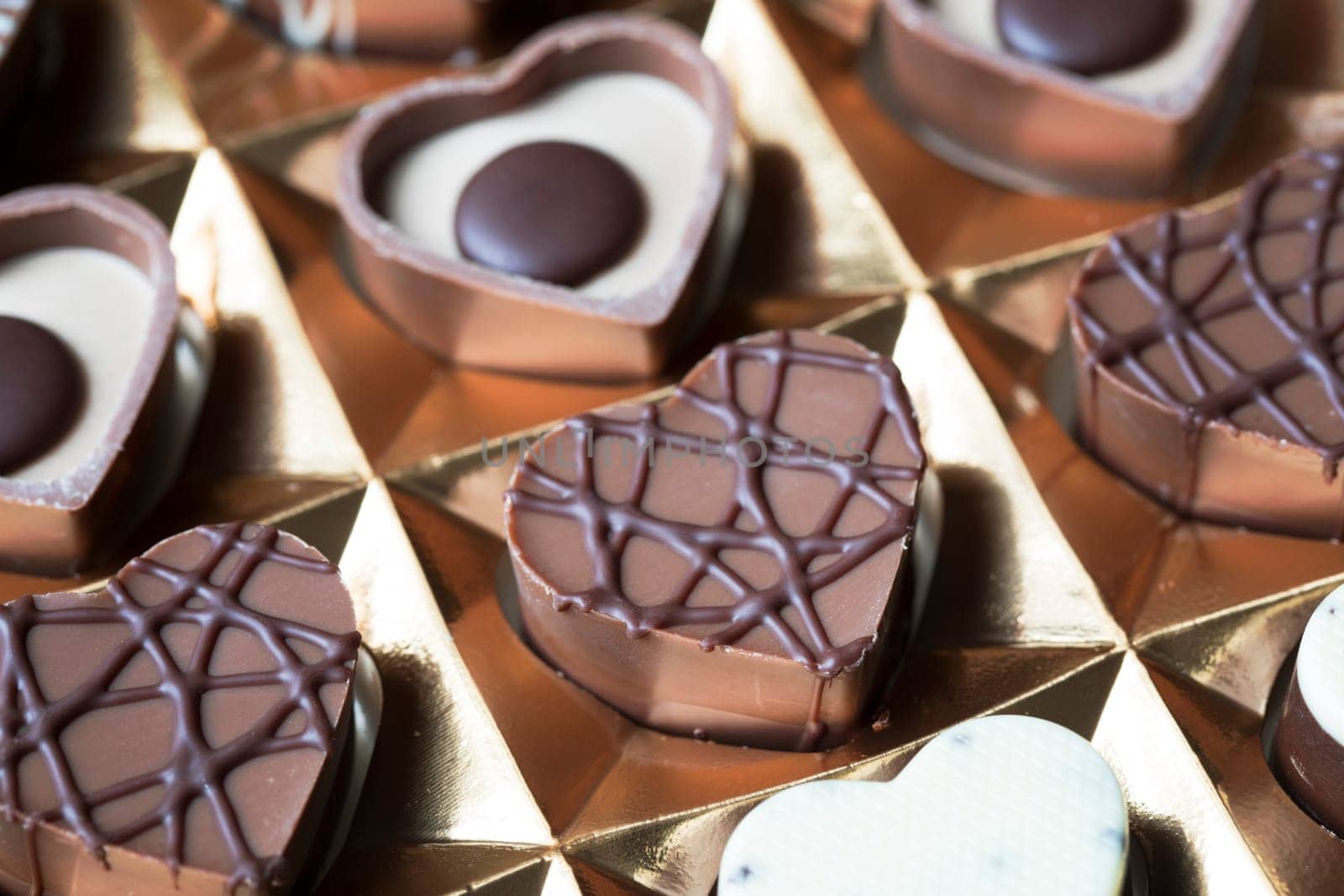 Close up of heart shaped chocolates in box.