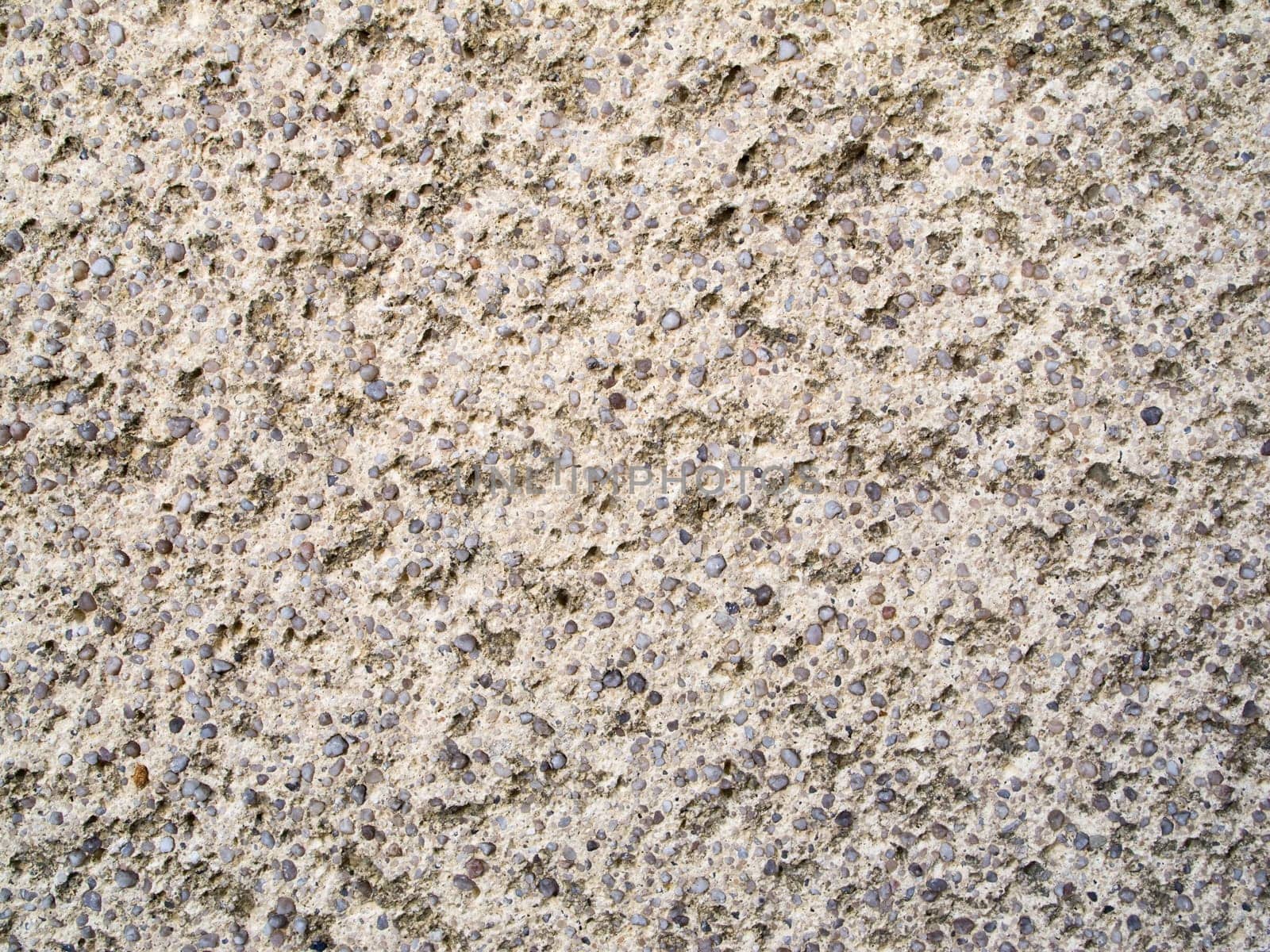 Format-filling view of a rough concrete surface with small pebbles