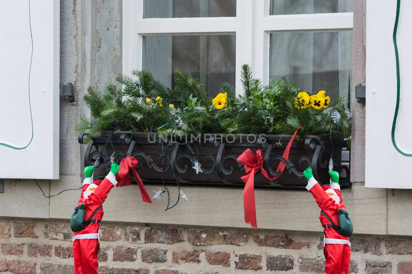 Christmas decoration with fir branches of a windowsill in the outdoor area..