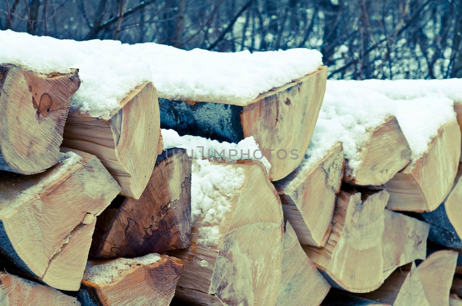 Natural wooden background Chopped firewood on stack