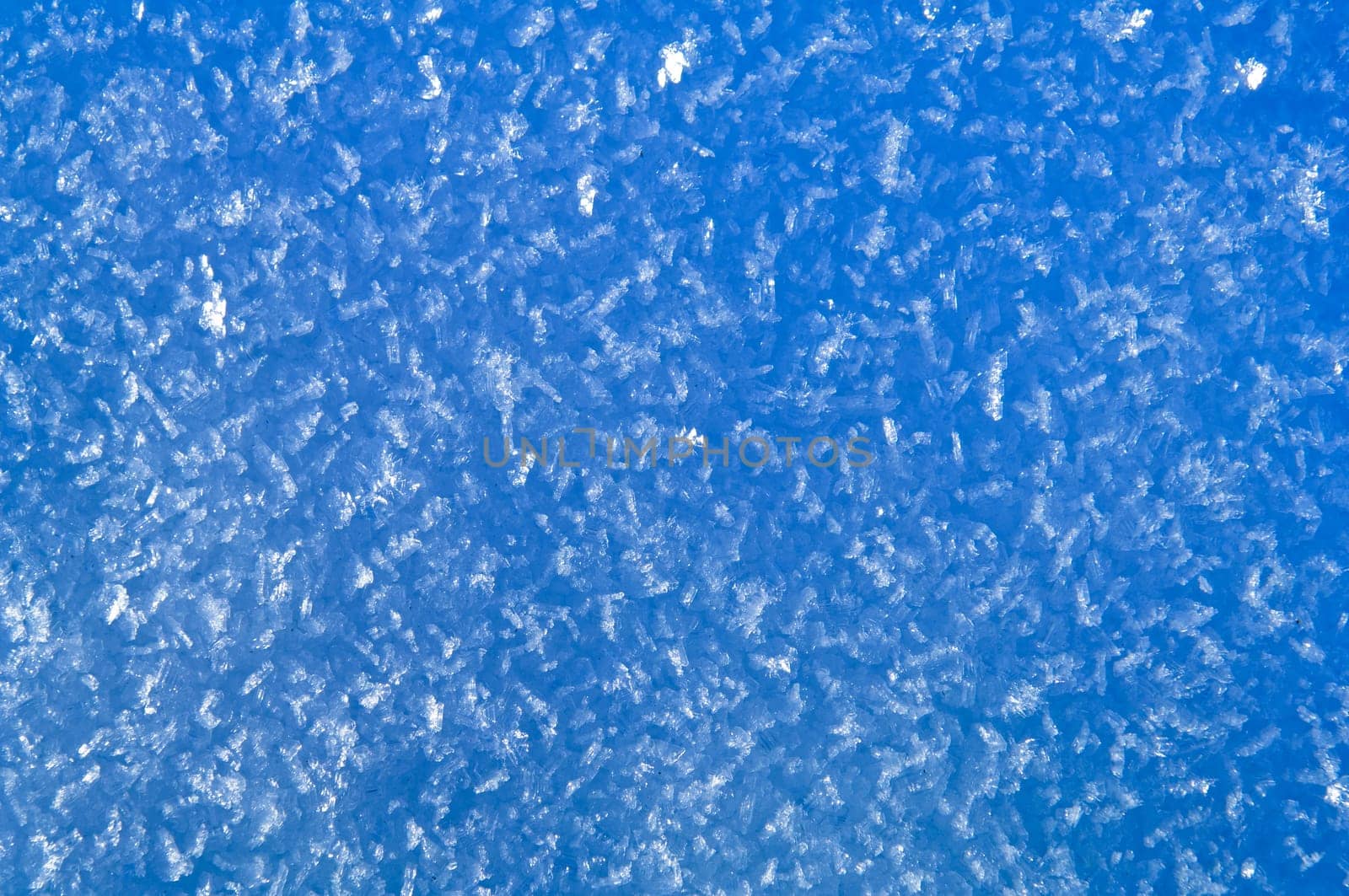 Blue snow and hoarfrost background with big transparent crystals