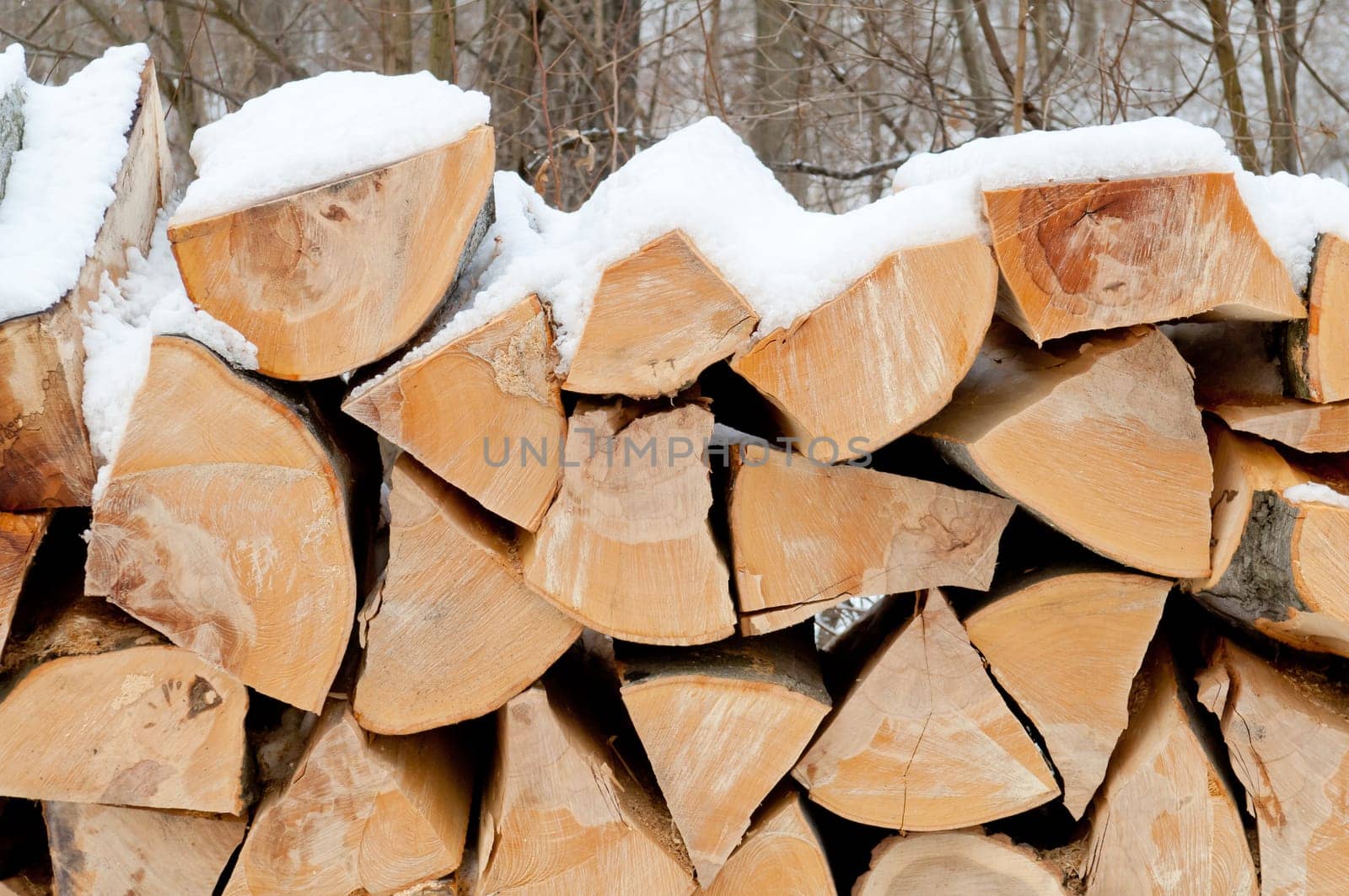 Natural wooden background Chopped firewood on stack
