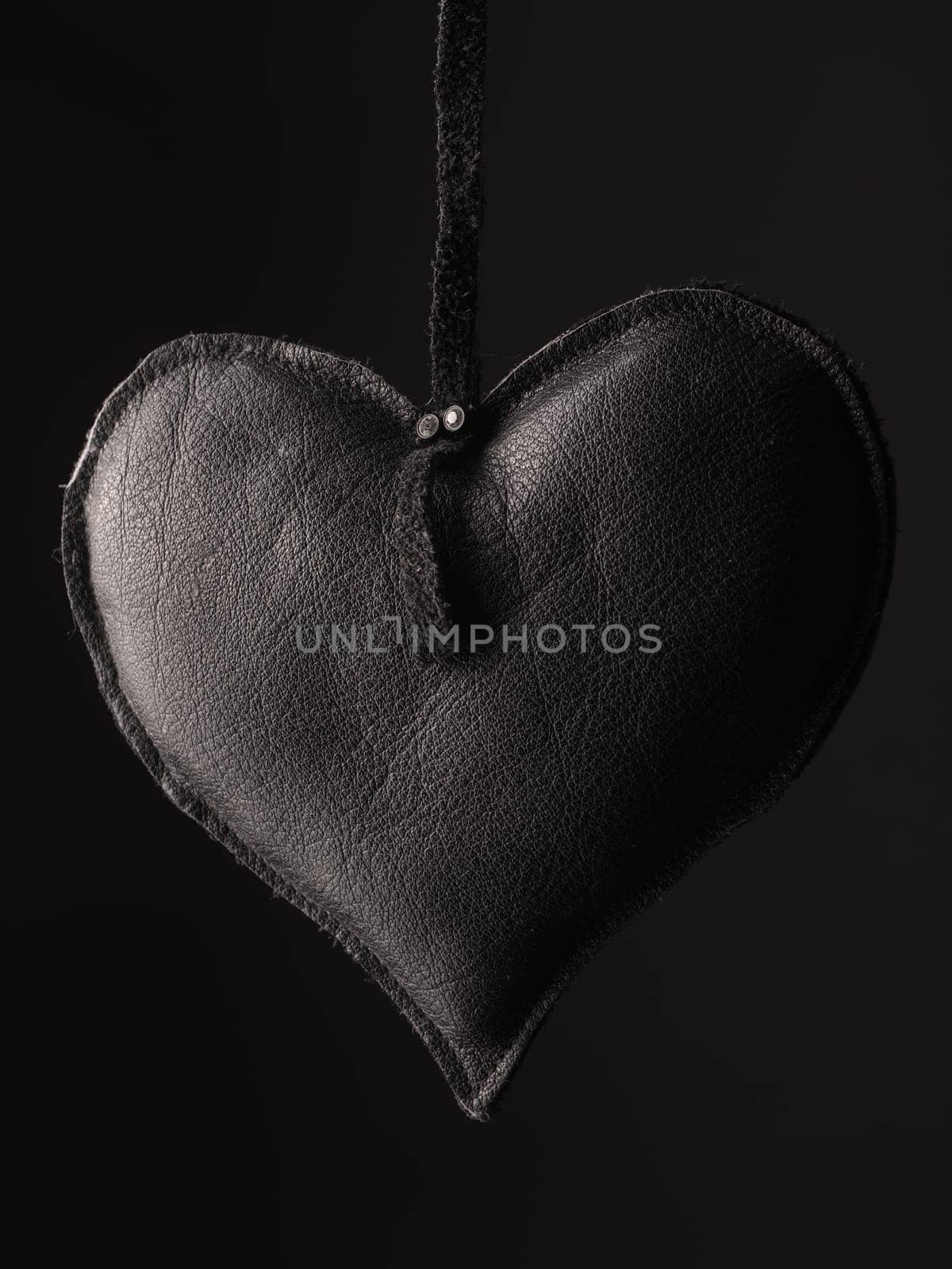Love concept image with a black leather heart shape using as background or greeting card