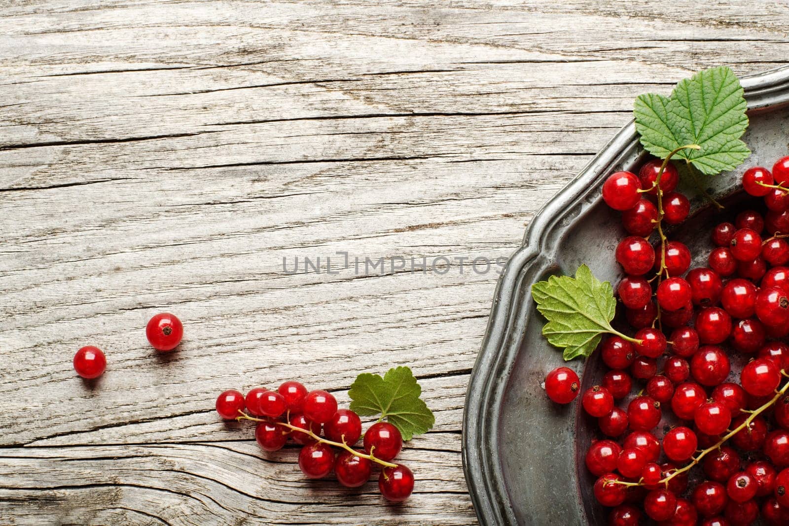 Fresh redcurrant on wooden background close up
