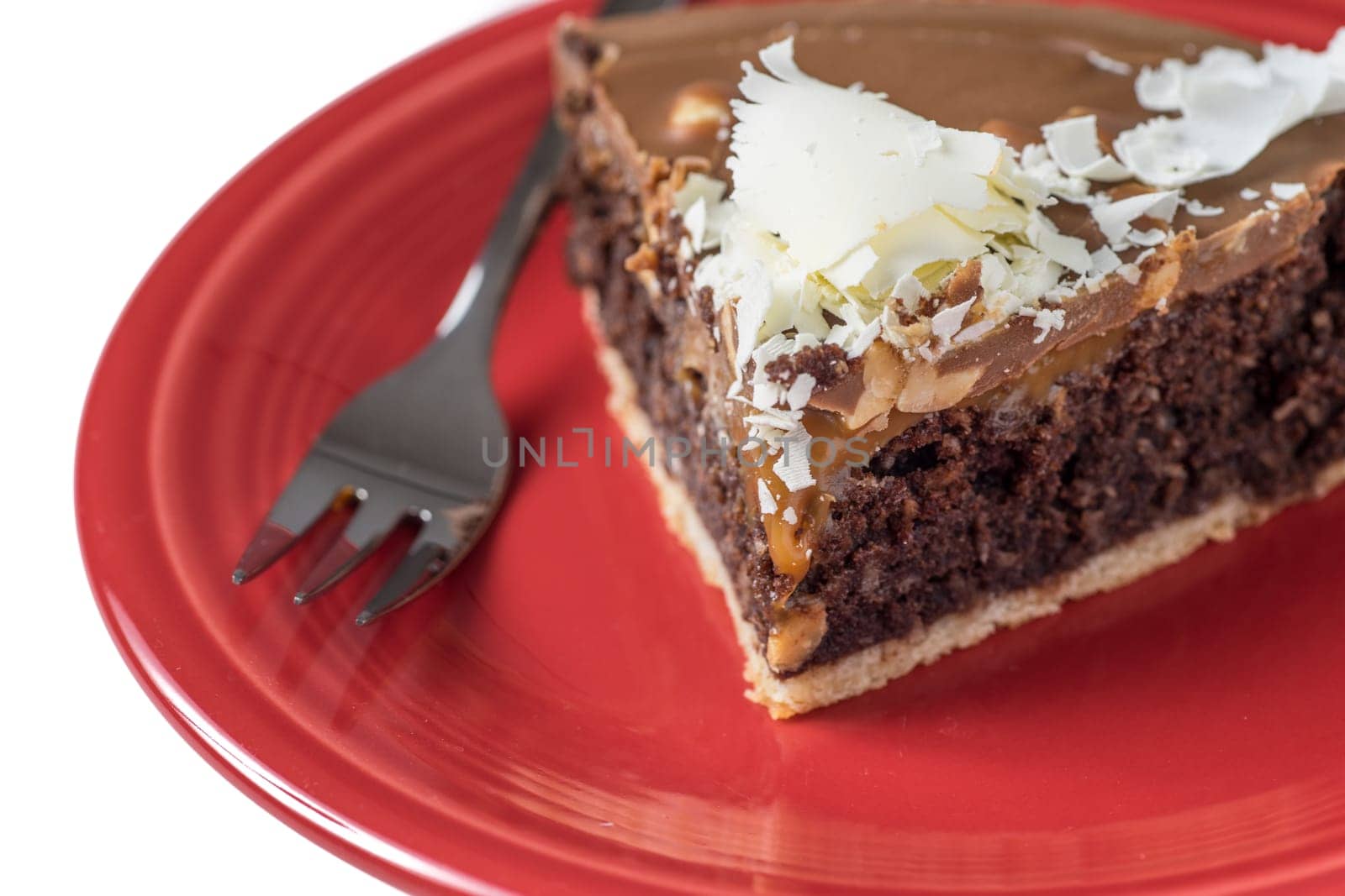 delicate round chocolate cake decorated with white chocolate flakes