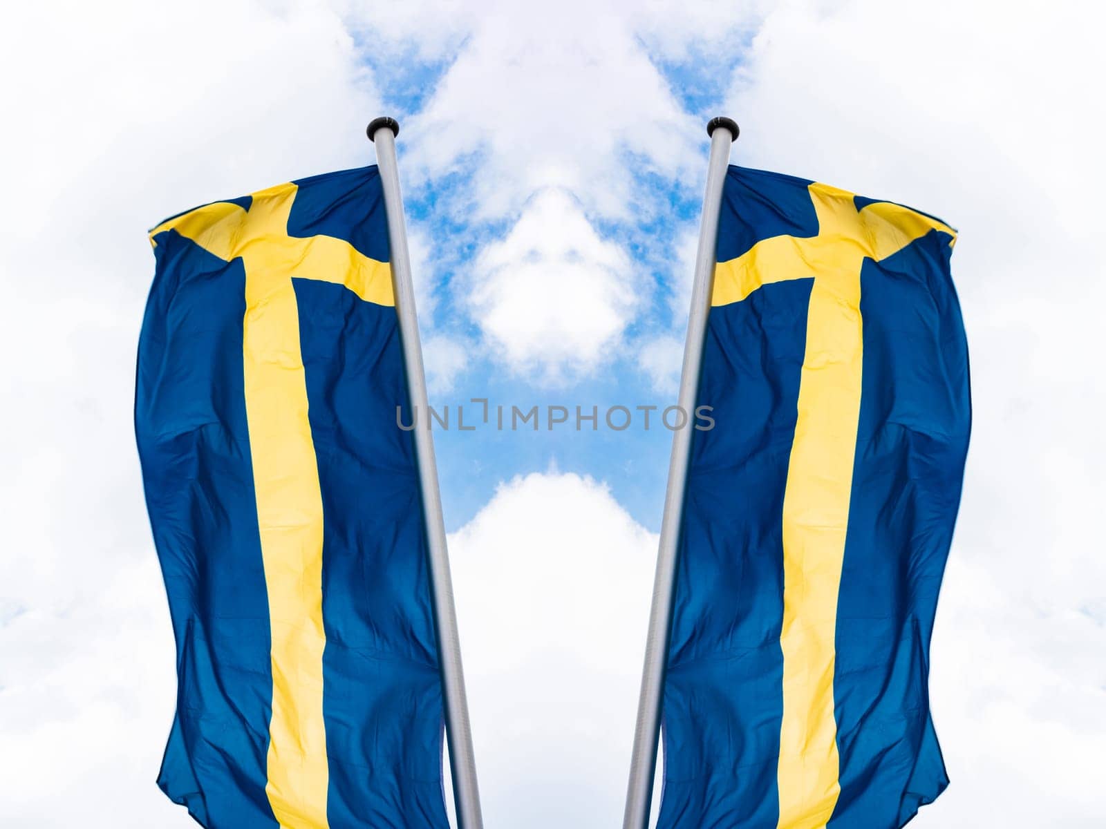Swedish national flag arranged in front of a blue sky.