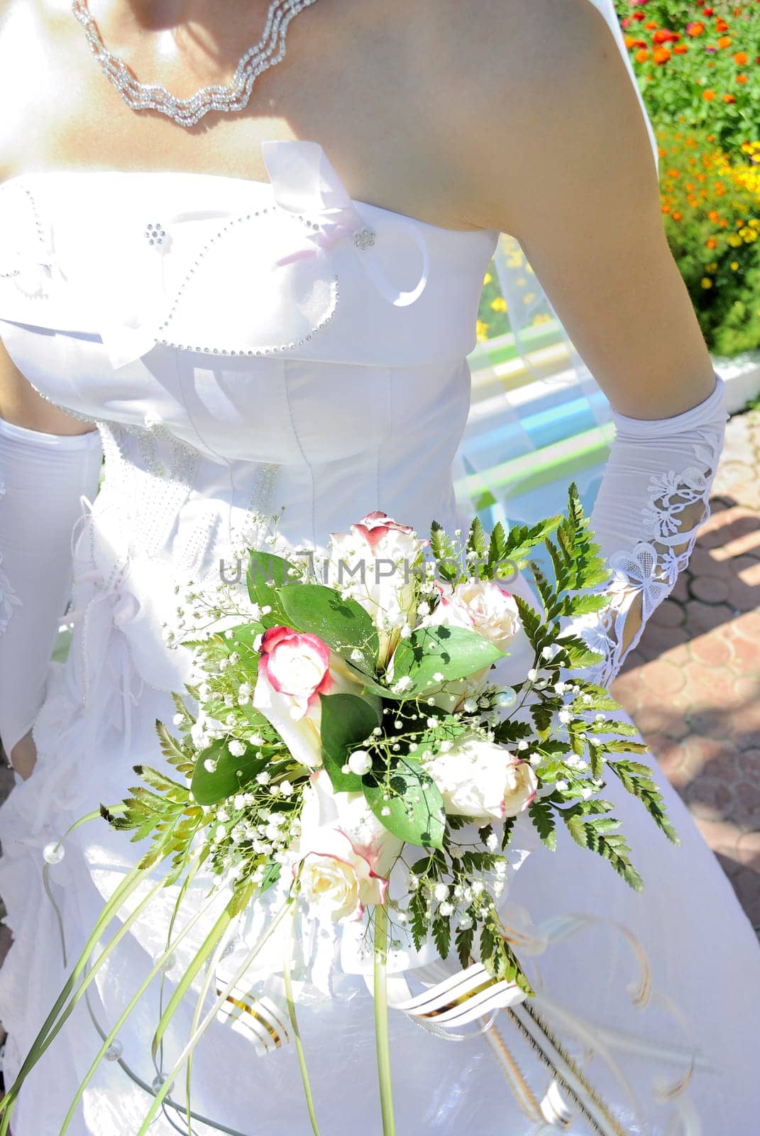 Beautiful white wedding bouquet in hands of the bride..