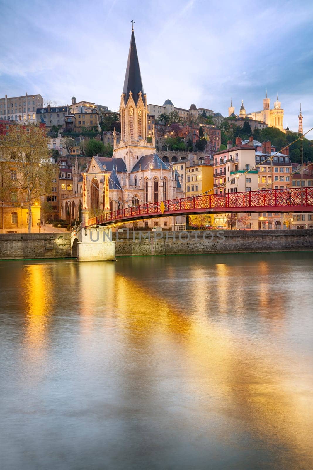 night view from St Georges footbridge in Lyon city with Fourviere cathedral, France