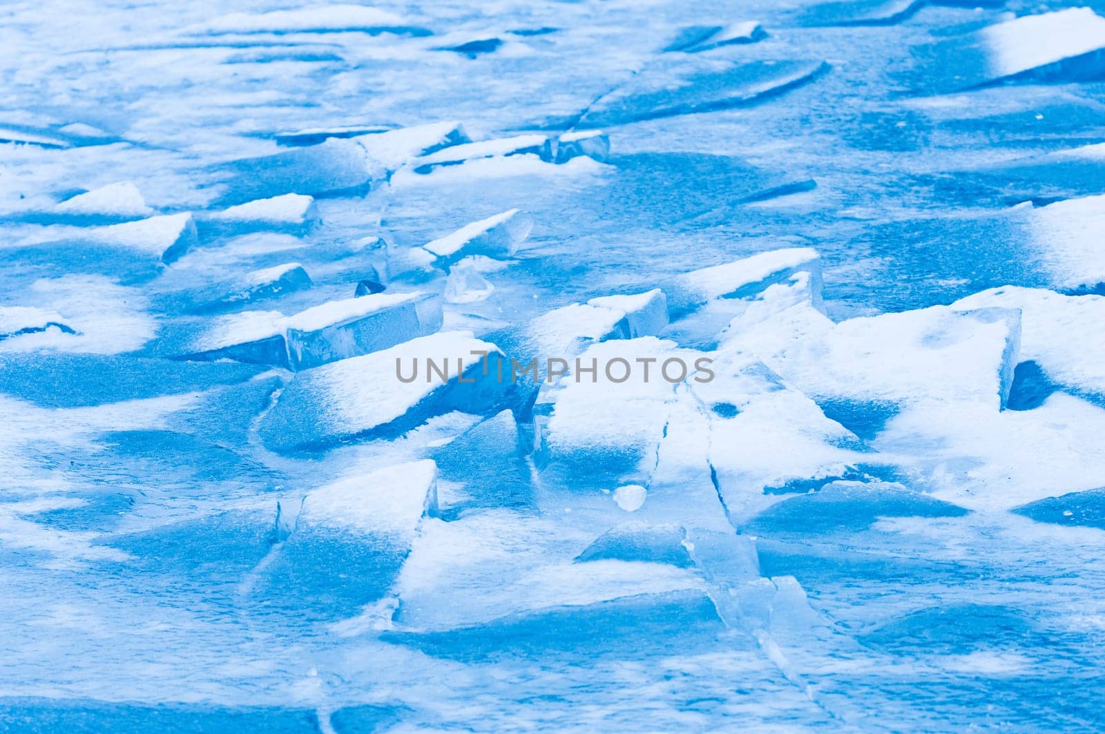Winter scene at a frozen lake with ice-pack and other ice formations