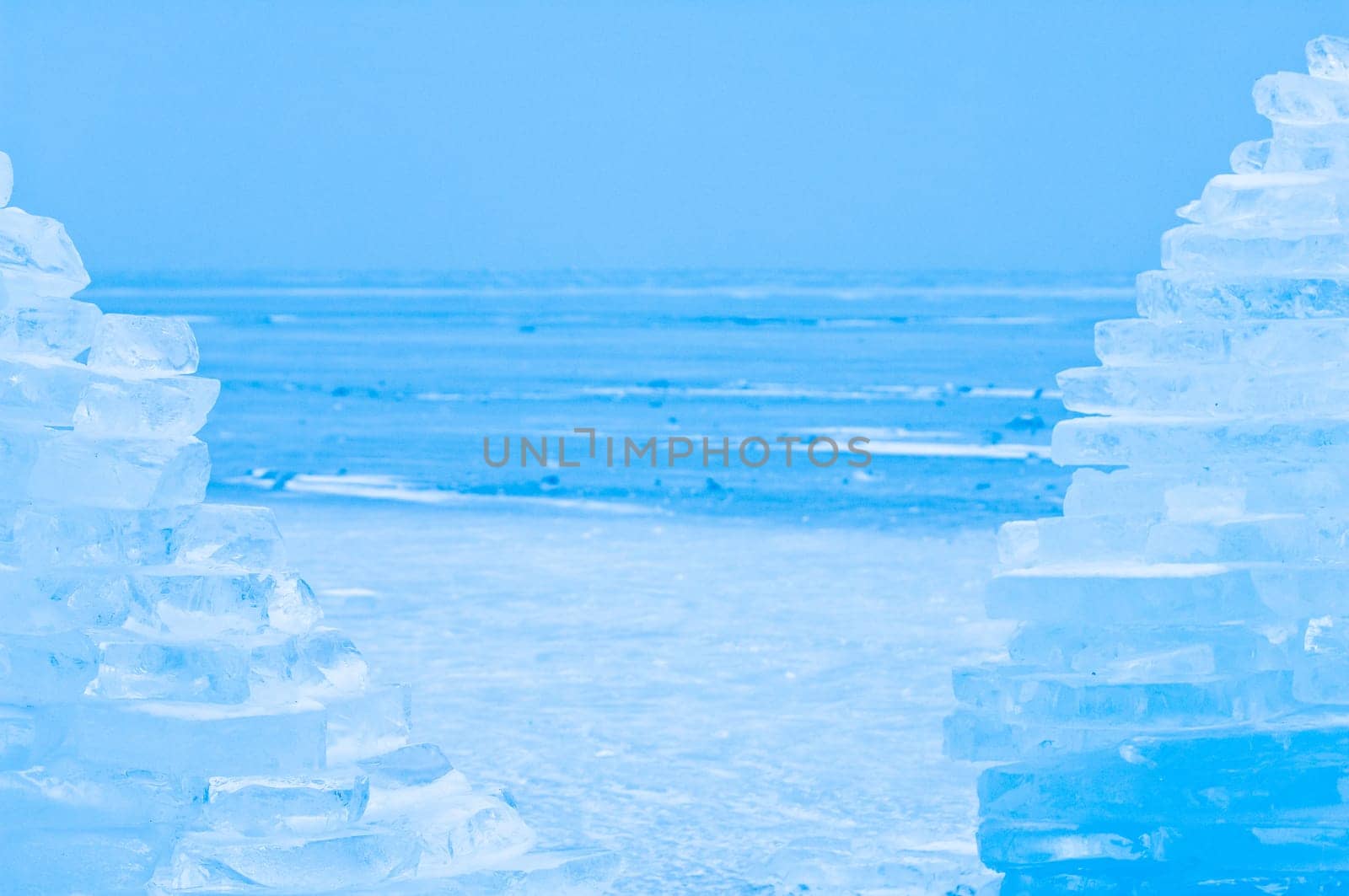 Winter scene at a frozen lake with ice-pack and other ice formations