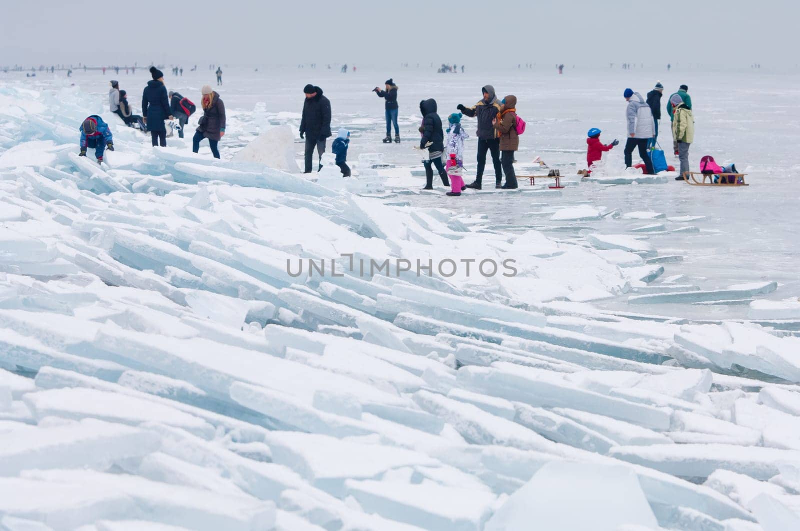 People walking and ice skating on the frozen Balaton Lake at Sifok, Hungary on 29th January, 2017