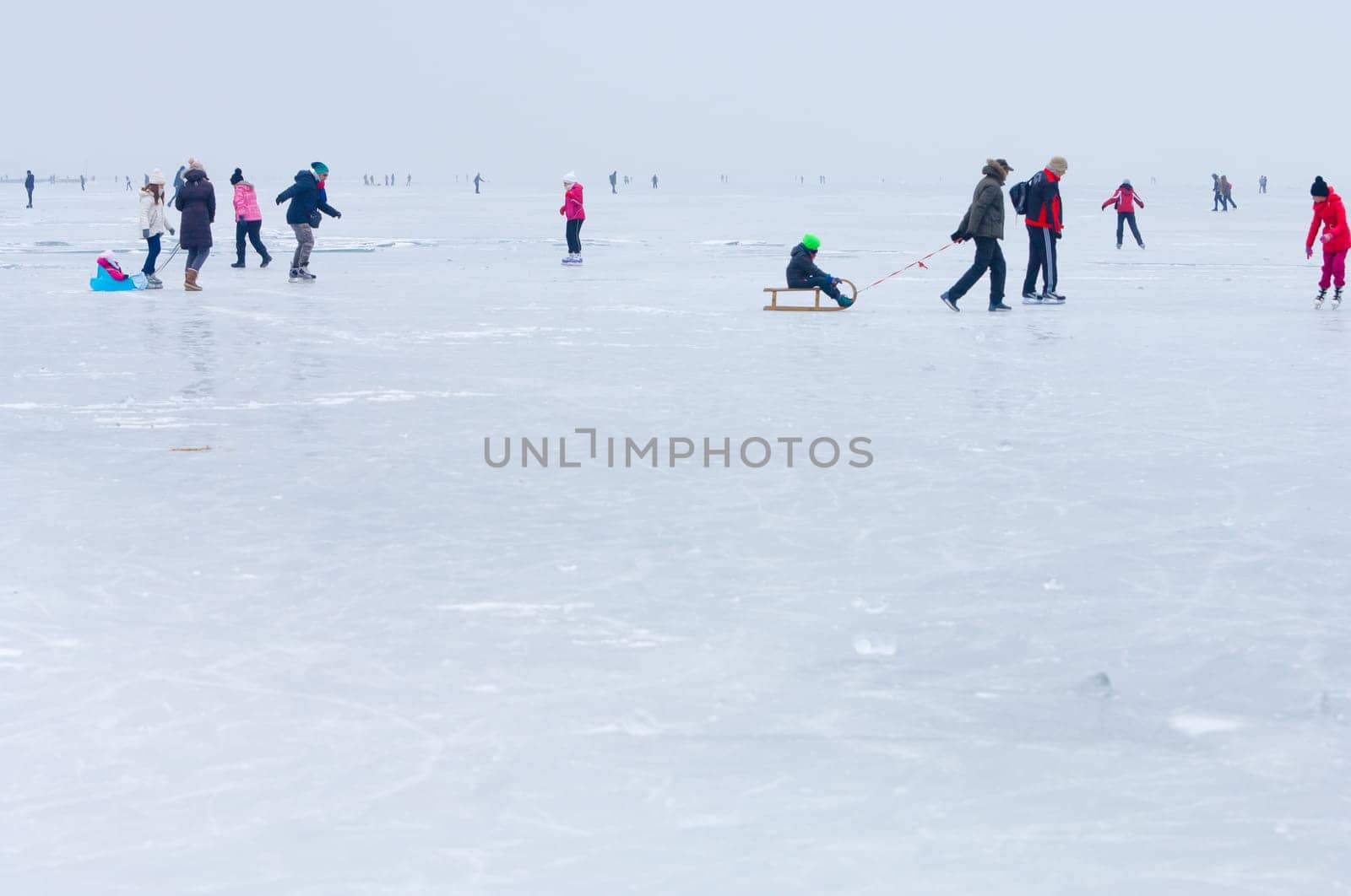 People walking and ice skating on the frozen Balaton Lake at Sifok, Hungary on 29th January, 2017