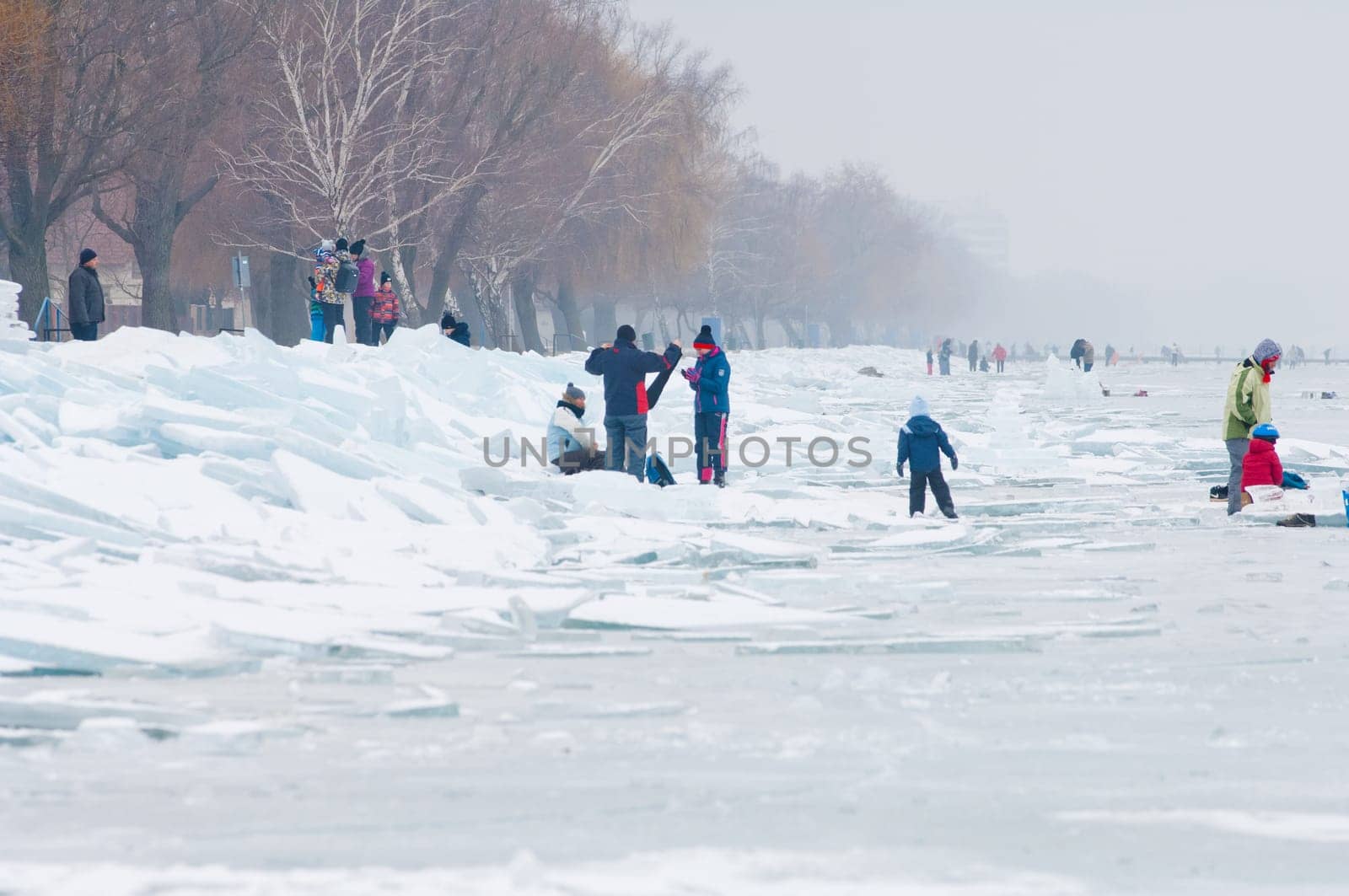 People walking and ice skating on the frozen Balaton Lake at Sifok, Hungary on 29th January, 2017