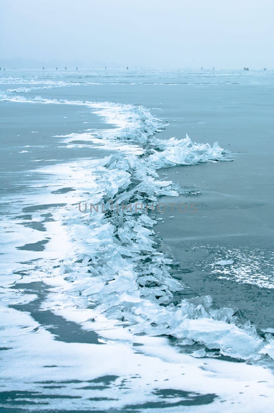 Winter scene at a frozen lake with ice-pack and other ice formations