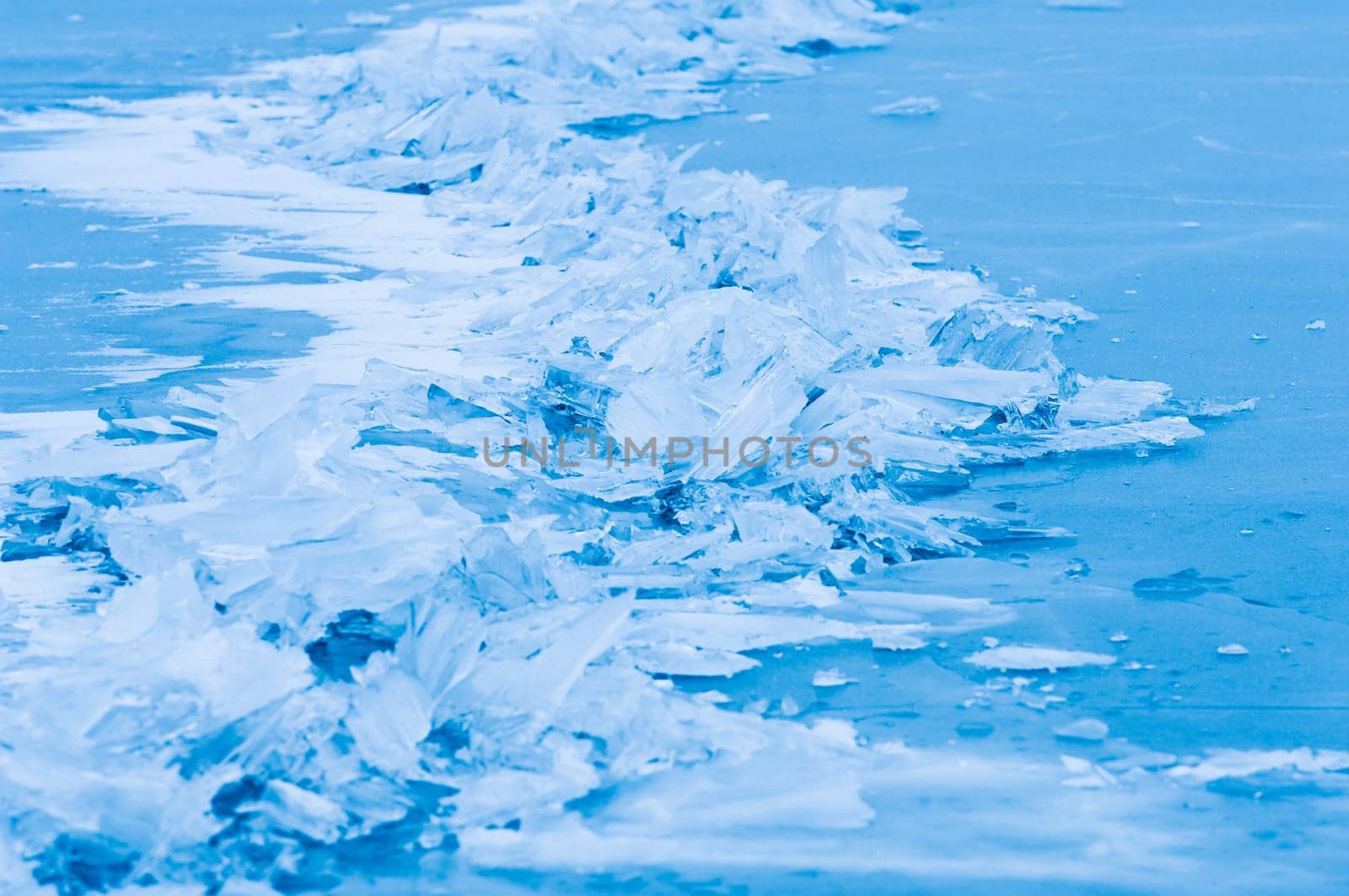 Winter scene at a frozen lake with ice-pack and other ice formations