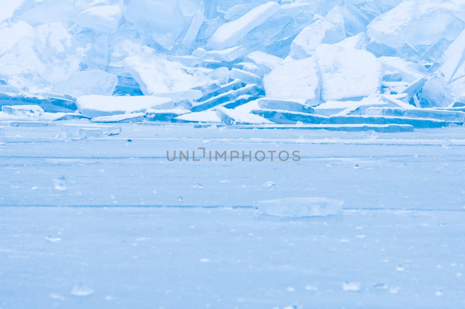 Winter scene at a frozen lake with ice-pack and other ice formations