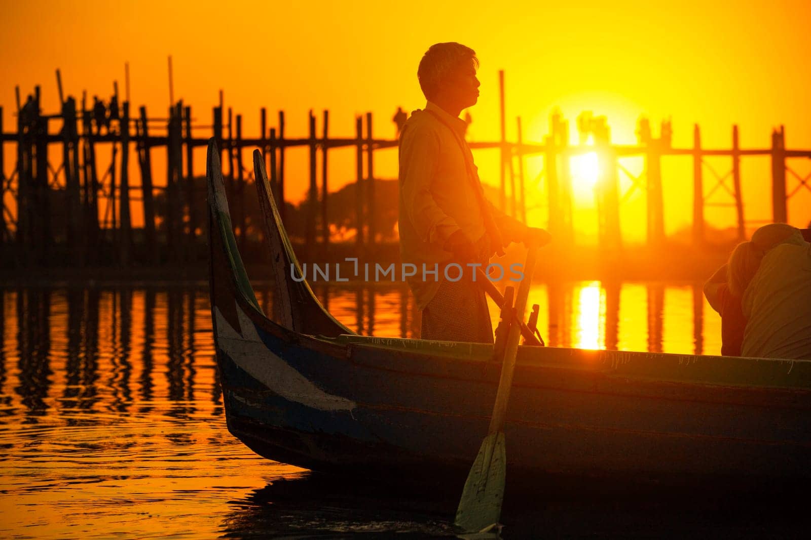 Fishman under U bein bridge at sunset, Myanmar landmark in mandalay