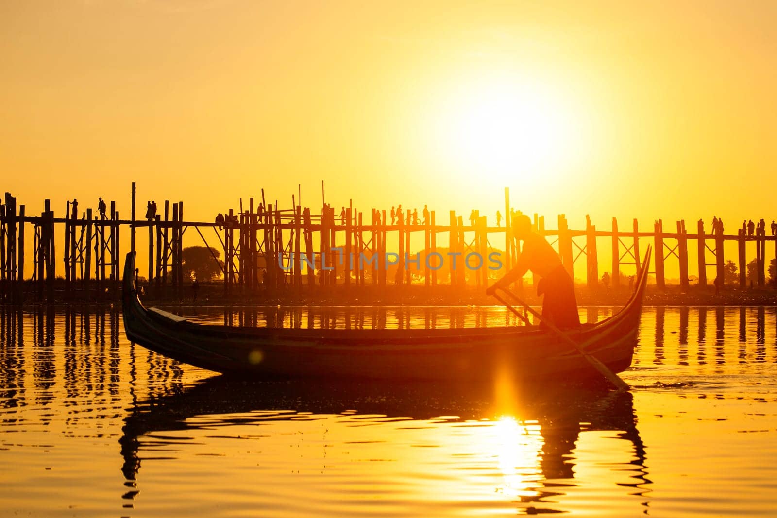 Fishman under U bein bridge at sunset, Myanmar landmark in mandalay