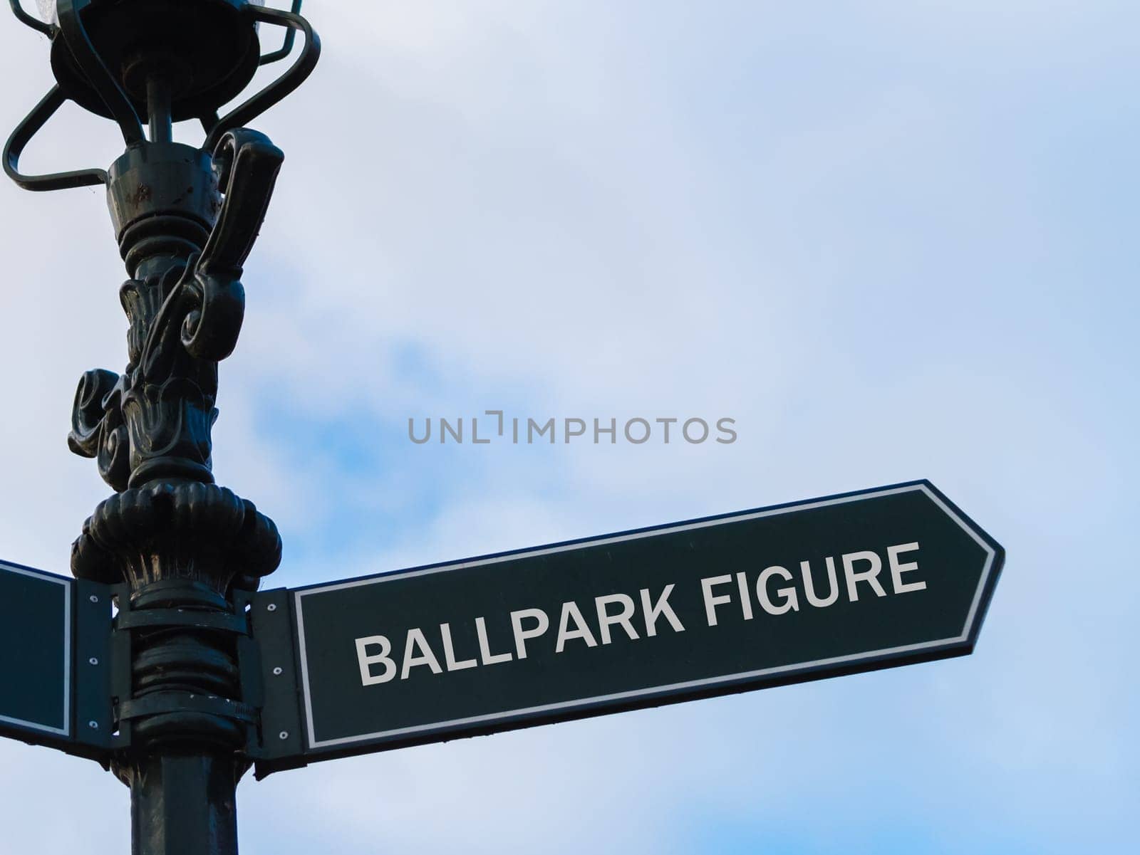 Street lighting pole with conceptual message Ballpark Figure on directional arrow over blue cloudy background.