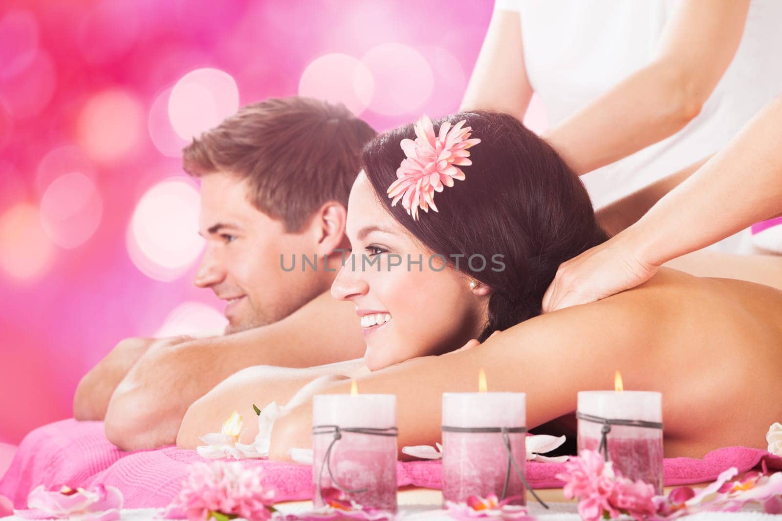 Close-up Of A Young Smiling Couple Receiving Shoulder Massage At Beauty Spa