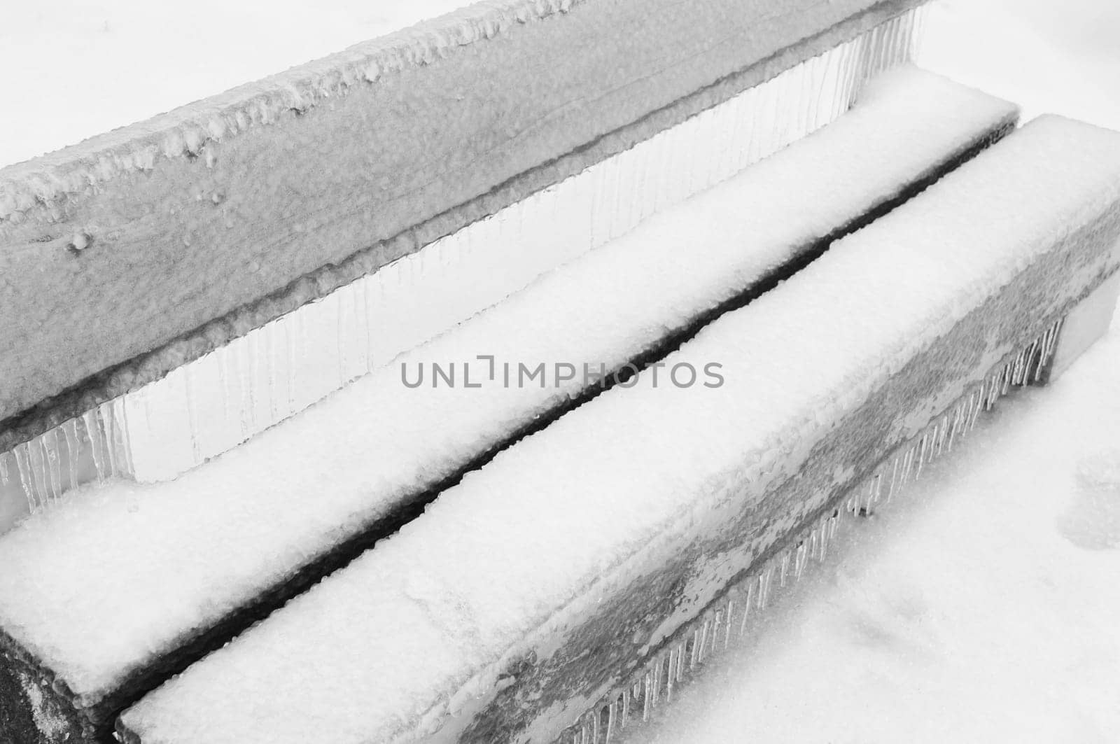 Freezing rain or sleet covered bench in a park