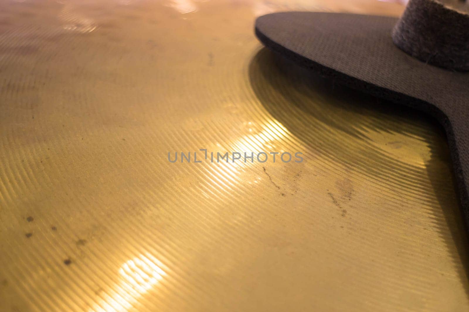 Metallic drum plate in white room, stock photo