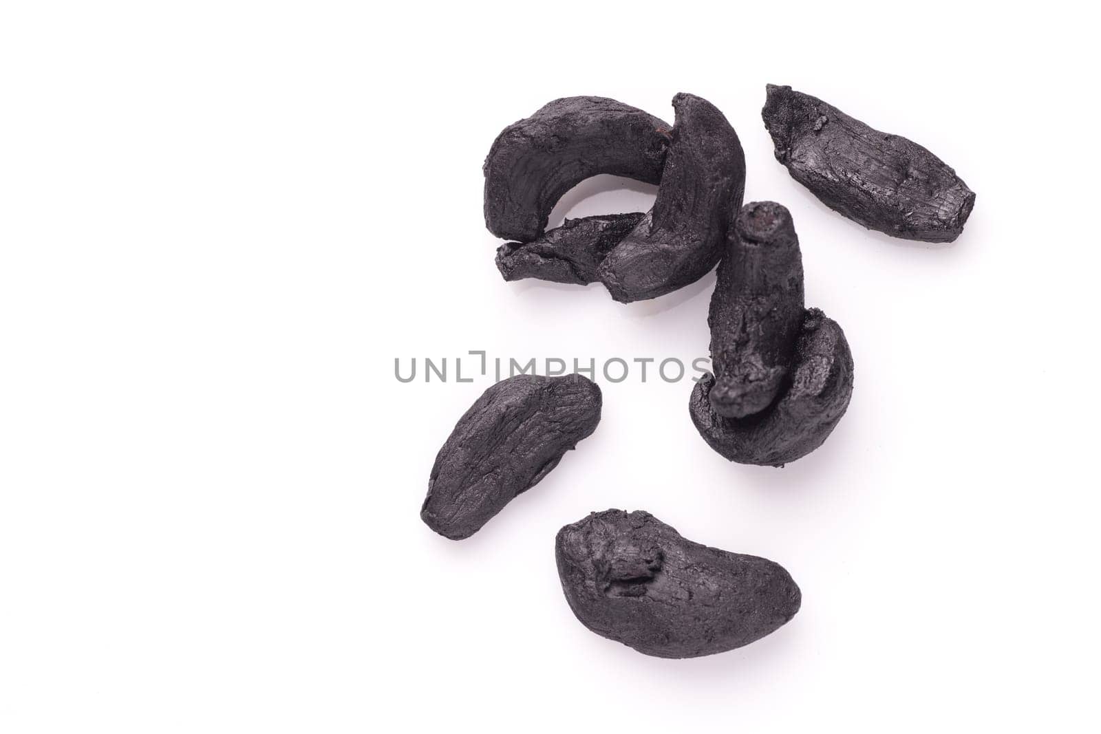 Pile of Black Garlic isolated on white background