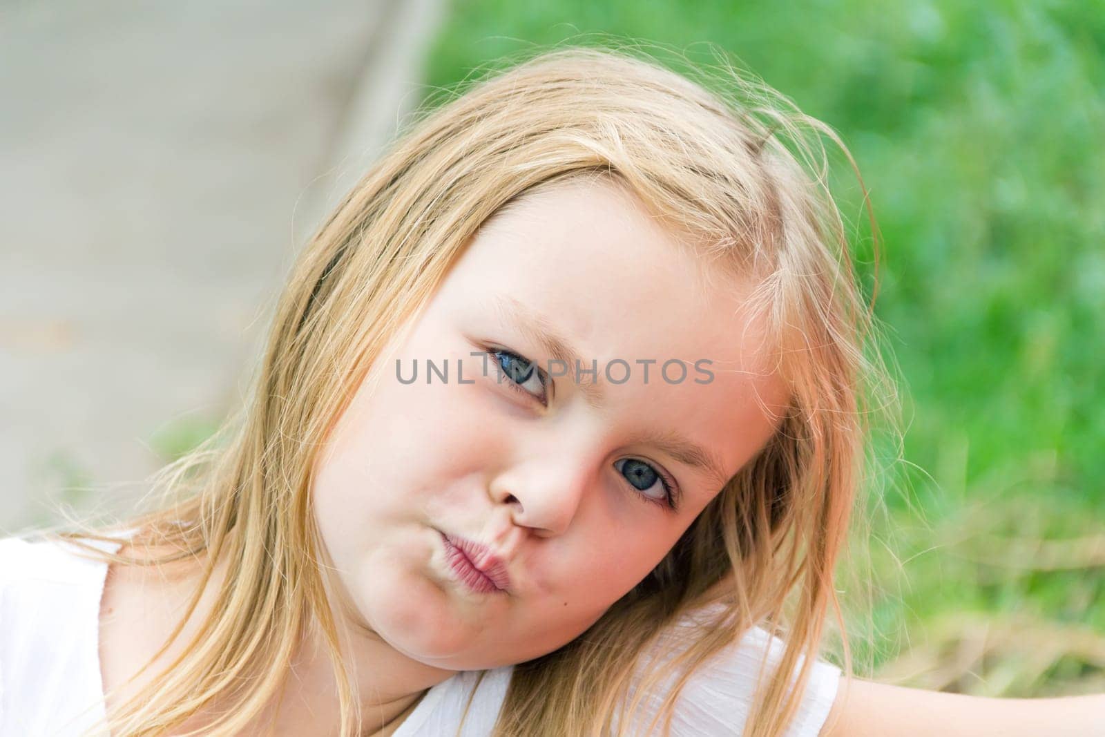 Cute girl with blond long hair and blue eyes
