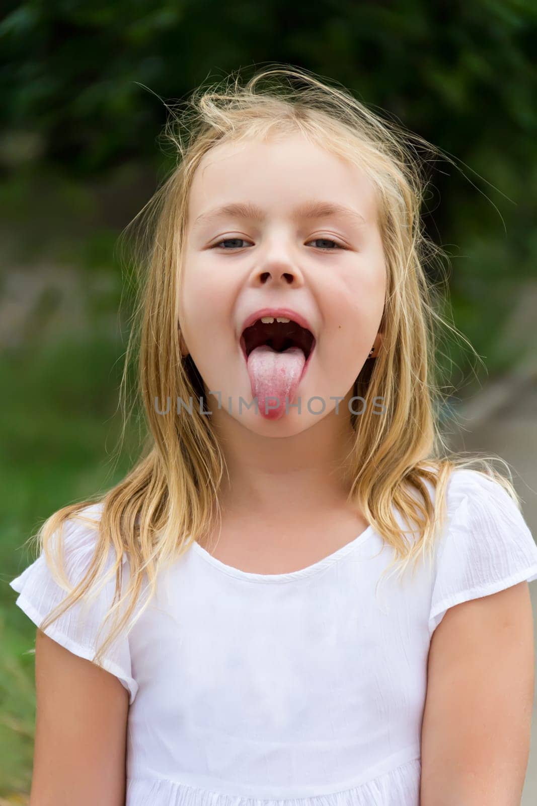 Portrait of cute girl with put out tongue