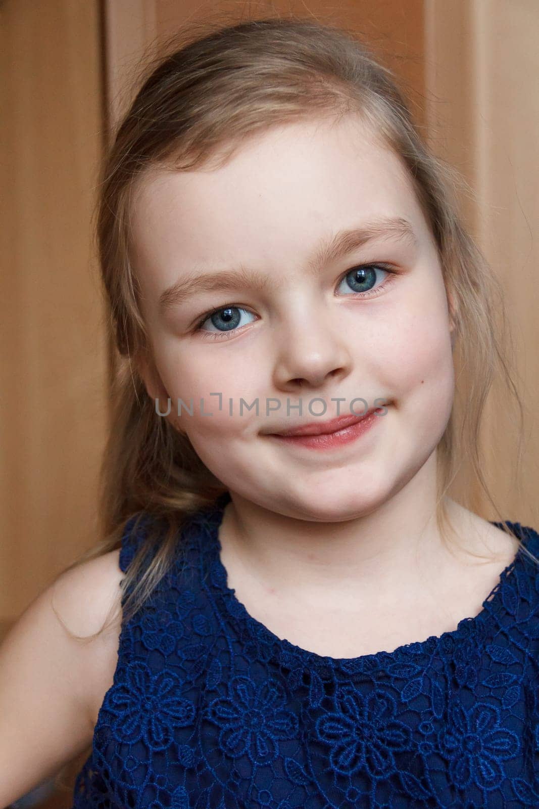 Portrait of beautiful caucasian blonde girl smiling indoor