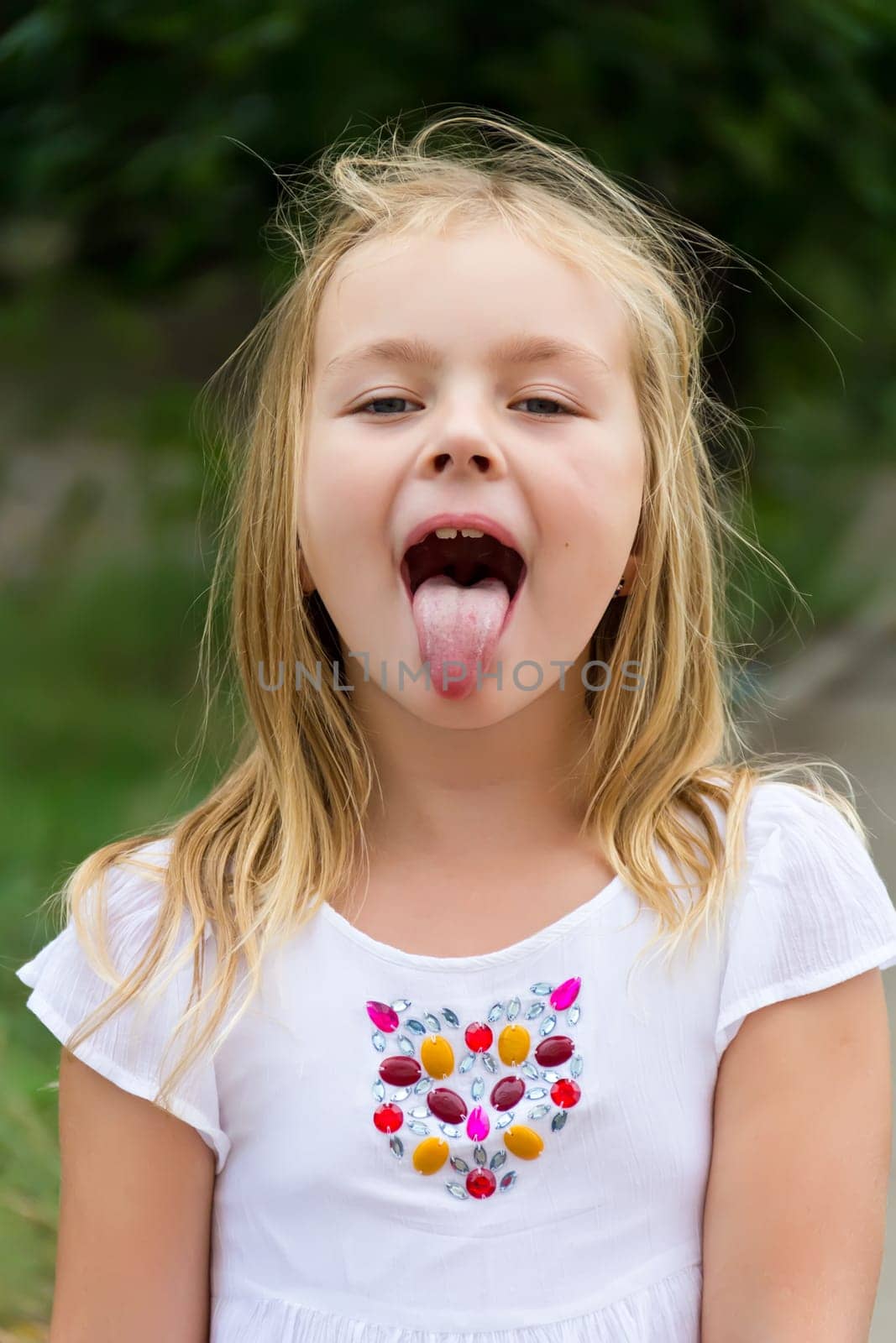 Portrait of cute girl with put out tongue