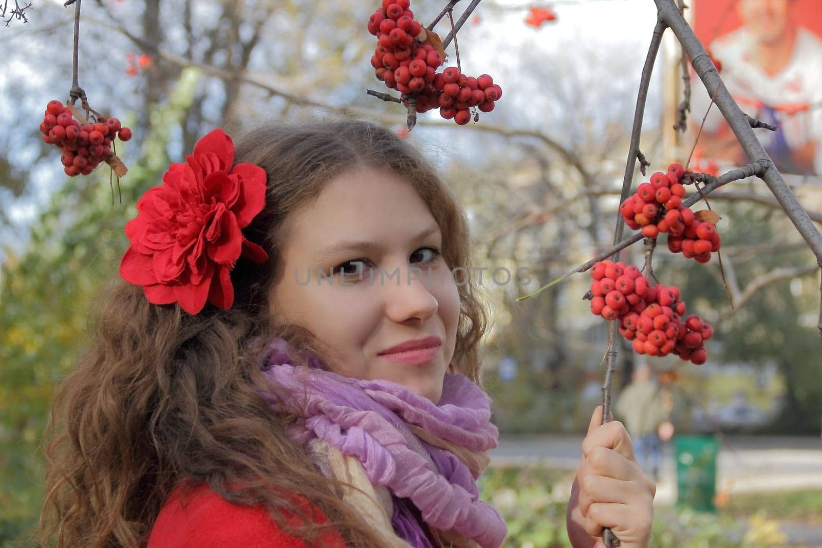 Image of beautiful young woman with autumn leaves